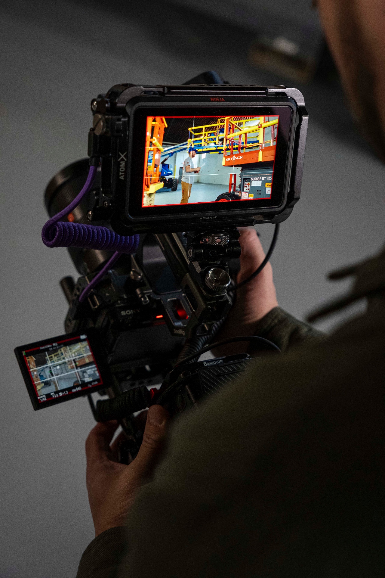 Director of photography framing a shot on a hand-held cinema rig