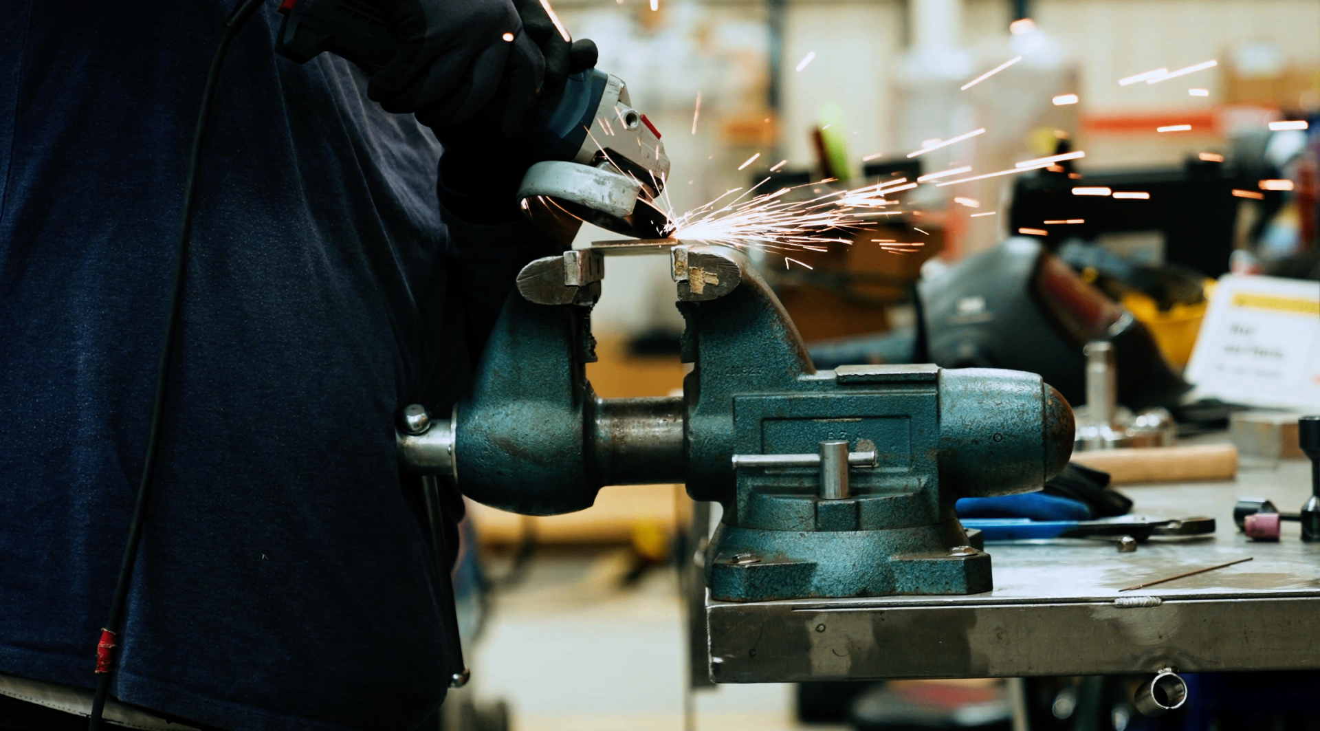 Angle grinder throwing sparks in a workshop