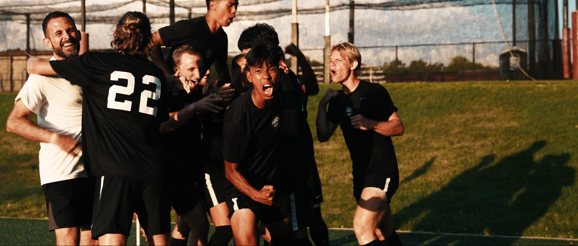 Chicago Eagles players celebrating a goal at golden hour