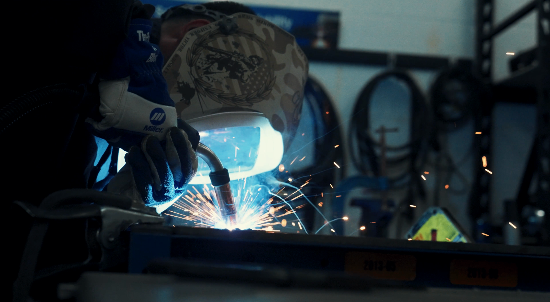 Portrait of a welder working under a hood